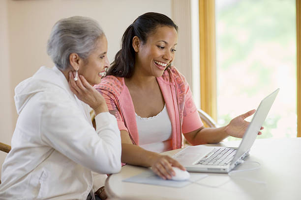 Mother and daughter sharing computer stock photo