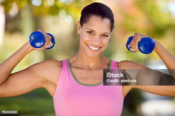 A Woman Lifting Weights Happy To Be Working Out Stock Photo - Download Image Now - Adult, Adults Only, African Ethnicity