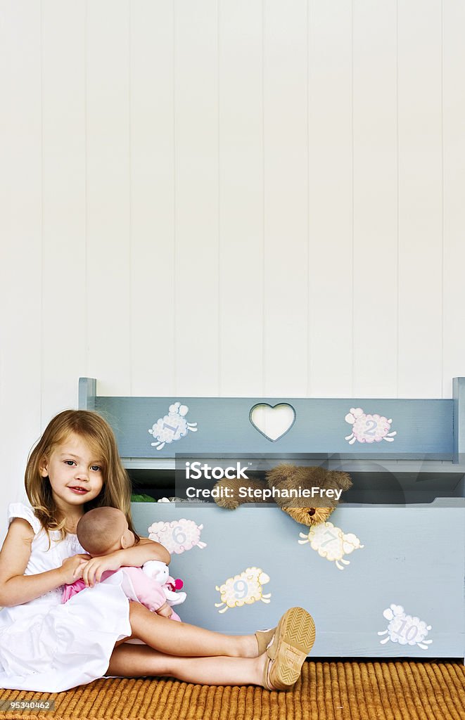 Child with doll and toy chest  Toy Stock Photo