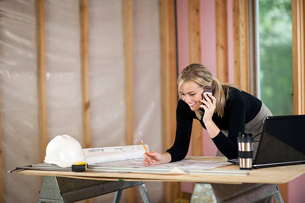 A businesswoman working on a construction site stock photo