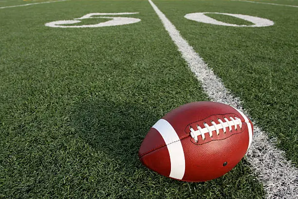 Photo of American Football near the Fifty Yard Line