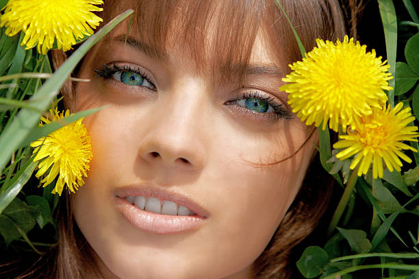 The beautiful girl among dandelions stock photo