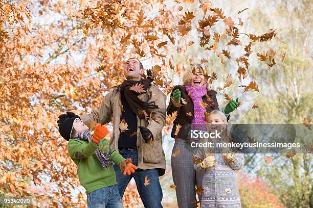 Father Throwing Autumn Leaves Stock Photo - Download Image Now - Family, Leaf, Autumn