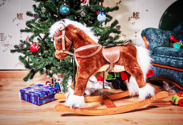 istock Children's hobbyhorse on the christmas tree background 953423048