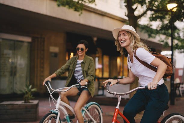 istock Female friends enjoying bicycle ride 953423130