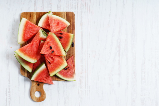 Watermelon Cut into Wedges on wooden background