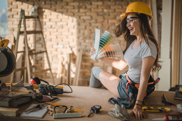 istock Cheerful construction worker having fun with color swatch. 953425602