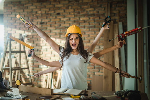 multi-tasking construction worker screaming and looking at camera. - home improvement work tool hammer portrait imagens e fotografias de stock
