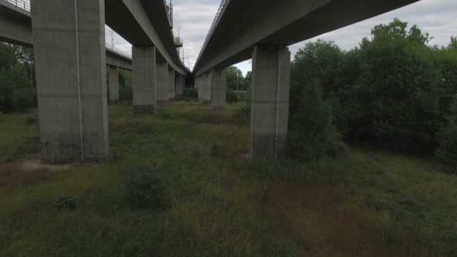 Drone shot flying under high bridge