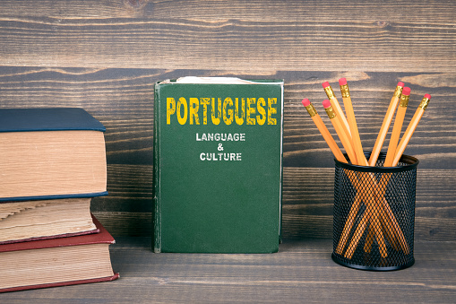 Portuguese language and culture concept. Book on a wooden background