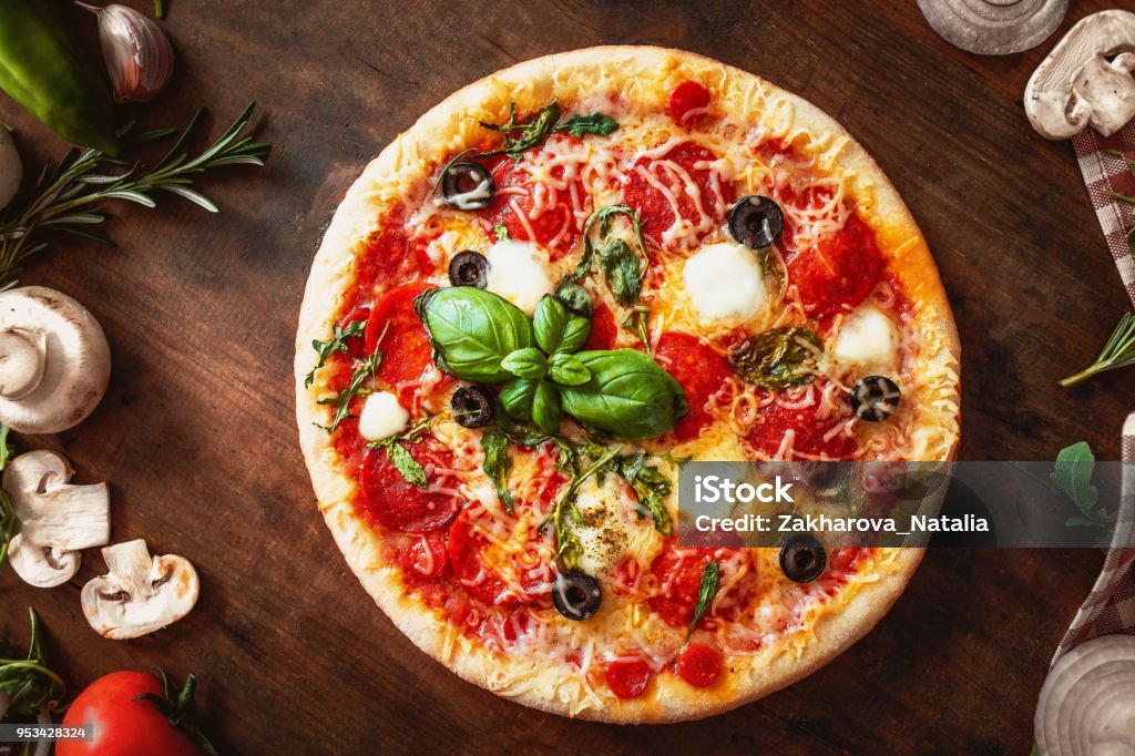 Hot pizza with Pepperoni  with vegetables and fresh ingredients on rustic wooden table. Pizza menu. View from above. - Royalty-free Pizza Foto de stock