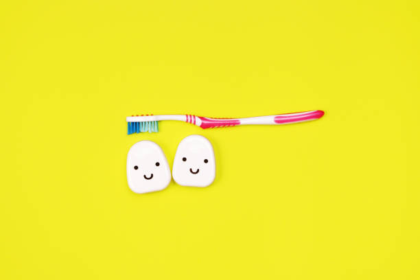 Toothbrushes on yellow background, Teeth cleaning concept stock photo