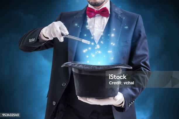 Magician Or Illusionist Is Showing Magic Trick Blue Stage Light In Background Stock Photo - Download Image Now