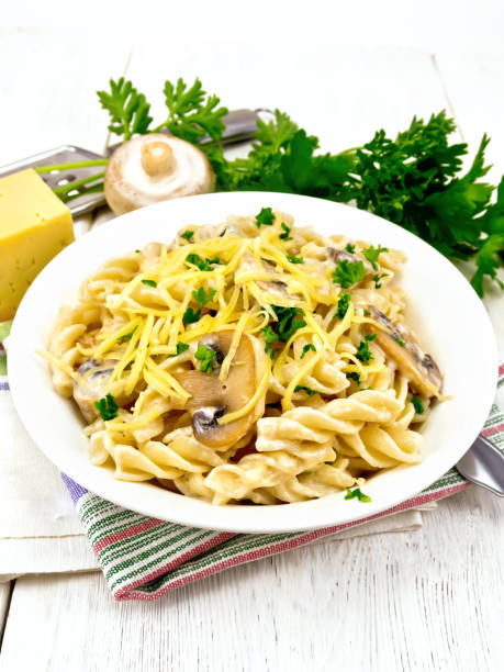 istock Fusilli with mushrooms and cream on light board 953432858