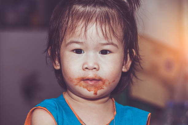 istock Child eating with a stained face. Do it yourself concept. Vintage tone. 953432900