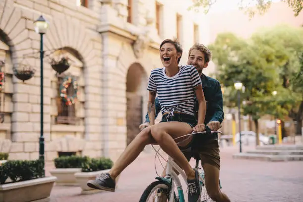 Photo of Couple enjoying a bicycle ride in the city