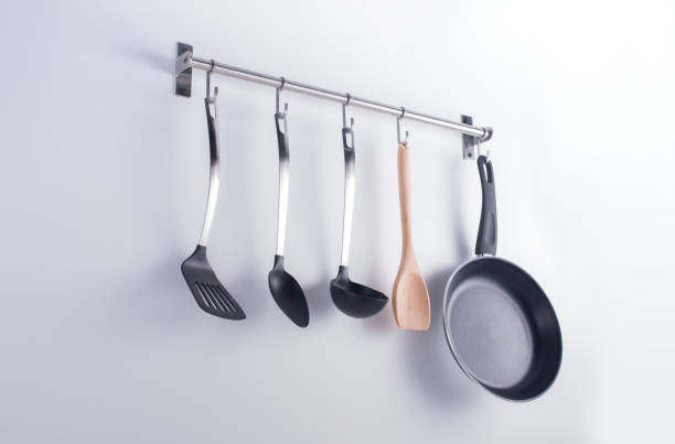 istock Hanged kitchen utensils Pans and Utensils Hanging on Kitchen Wall 953436632