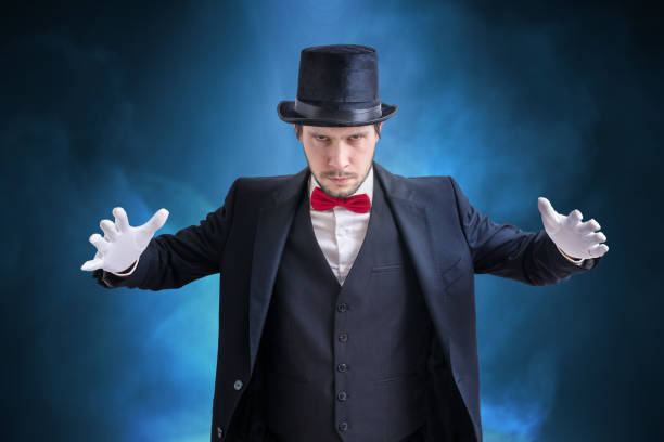 istock Young magician man is showing magic trick. 953436908
