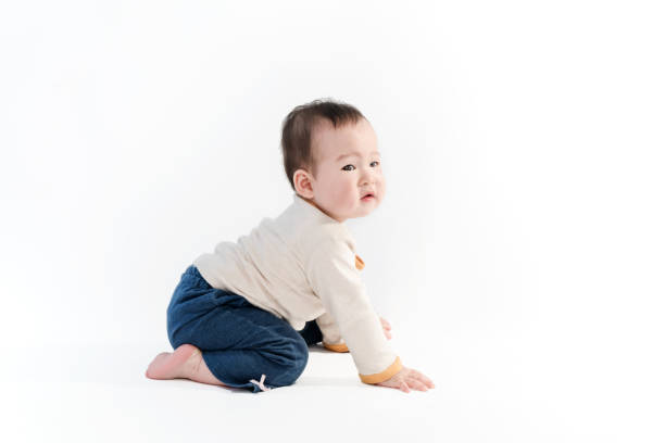 istock Cute baby sitting playing with color models in white background 953437958