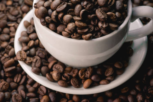 istock coffee in white cup and coffee beans are the background. 953439568