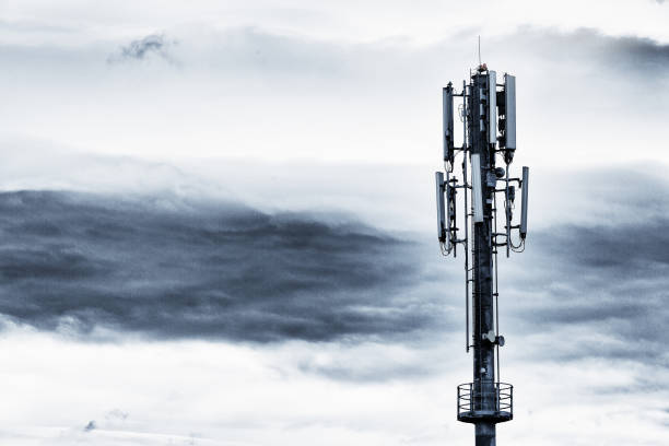 istock Cell phone base station mast against stormy sky 953440728
