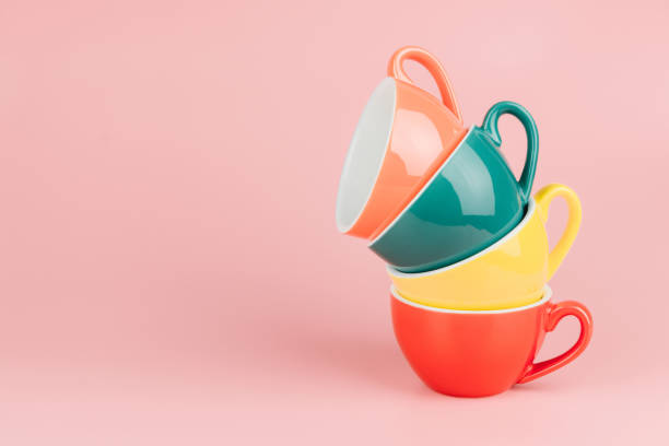 istock Colorful stack of cups for latte coffee on pink background with copy space. 953441680