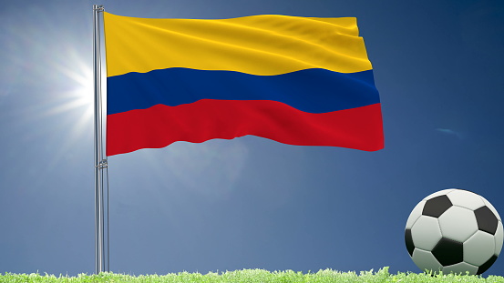 Flag of Colombia fluttering and a football rolls on the lawn, 3d rendering