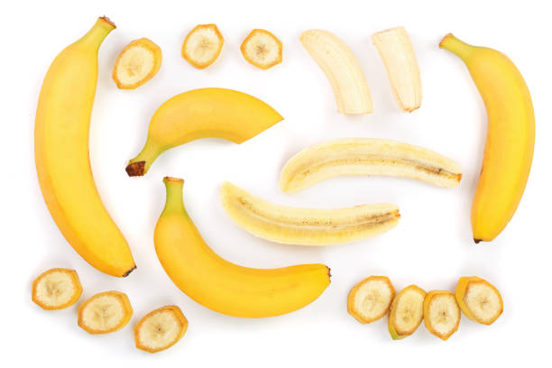 istock whole and sliced bananas isolated on white background. Top view. Flat lay 953443980