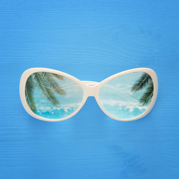 istock vacation and summer image with sunglasse over blue wooden background. 953445092
