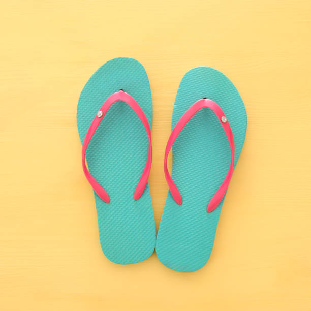 istock vacation and summer image with flipflops over yellow wooden background. 953445128