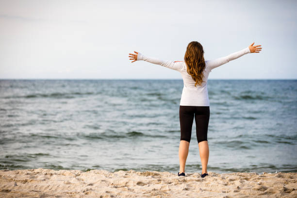 istock Nordic walking - young woman training on beach 953445730