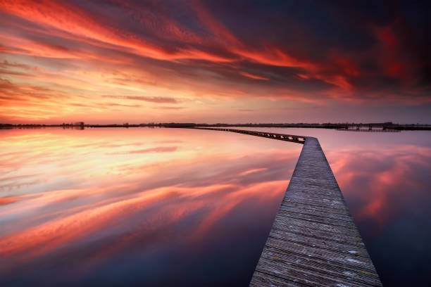 long pier on big lake at purple sunset