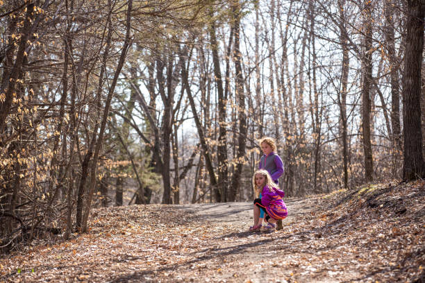 istock Two Young Girls Stopped on Trail in Woods 953446798