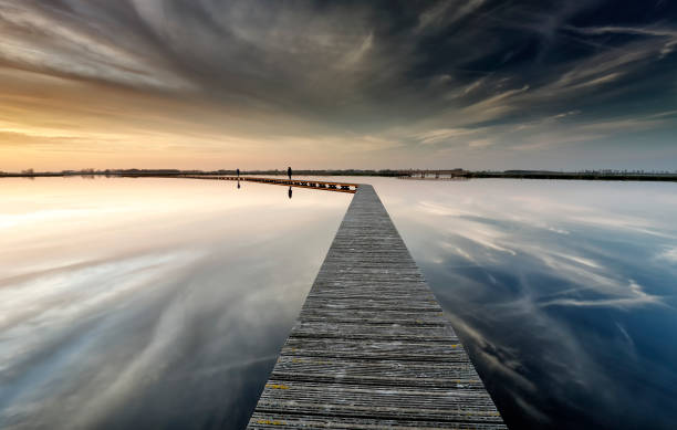 istock wooden path on water on big lake before sunset 953447014