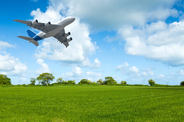 istock Flight of a passenger plane over the meadows 953447424