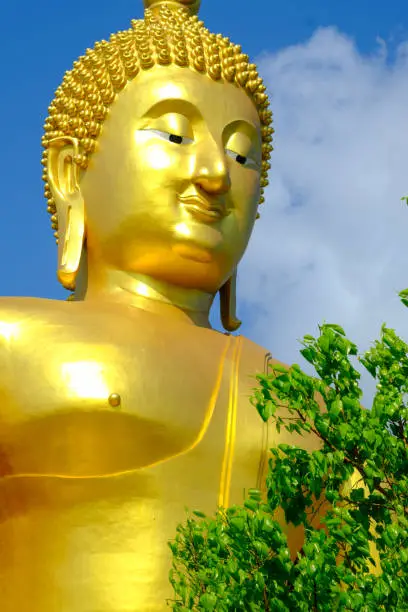 Face of Big golden Buddha with blue sky at Wat muang,Angthong,Thailand.