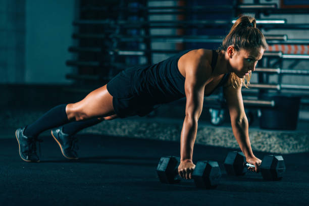 istock Cross training. Young woman exercising at the gym 953448918
