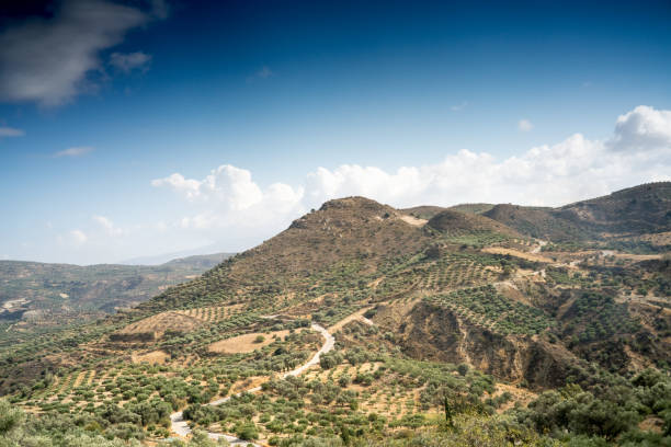 istock Field and mountain against cloudy sky 953452492