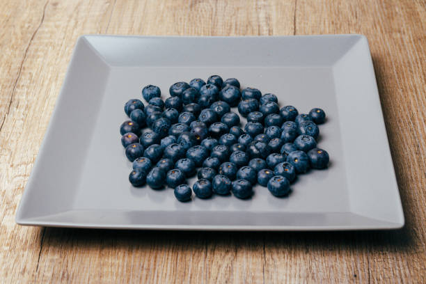 istock large, fresh blueberries lie on a gray plate, close-up 953452678