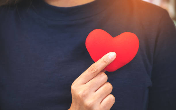 istock Closeup image of hands holding a red heart sign 953452736