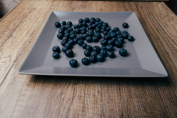 istock large, fresh blueberries lie on a gray plate, close-up 953453228