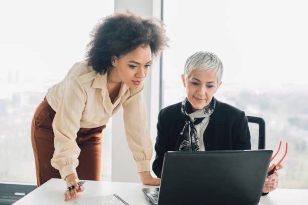 istock Female coworkers looking at laptop 953458630