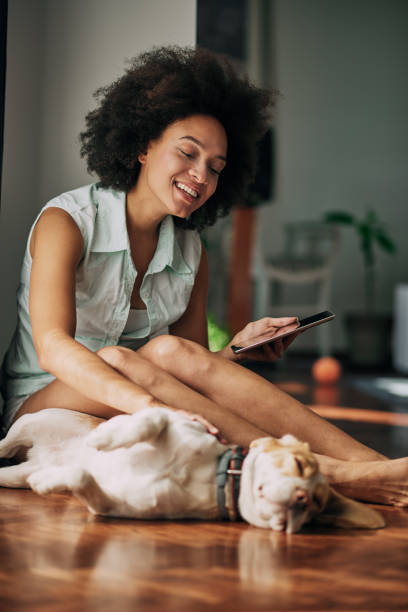 istock Mixed race woman petting dog. 953459788