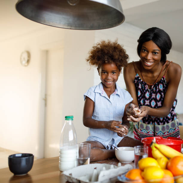 istock Mother and daughter enjoy making cookies in the kitchen 953462190