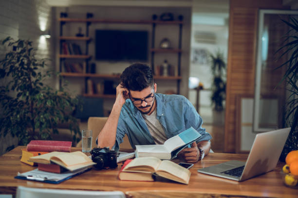 istock Young male student studying for the exams at home 953462844