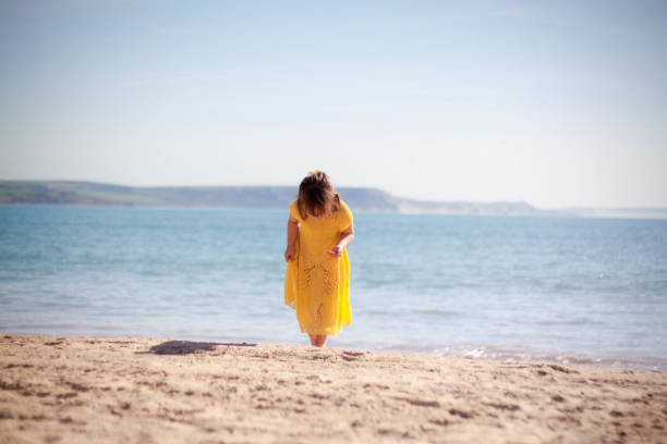 istock Happy little girl running on the beach 953464954