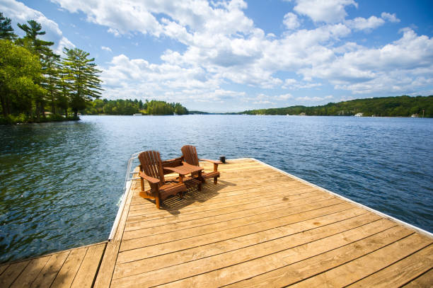 Adirondack chairs sitting on a wooden dock stock photo