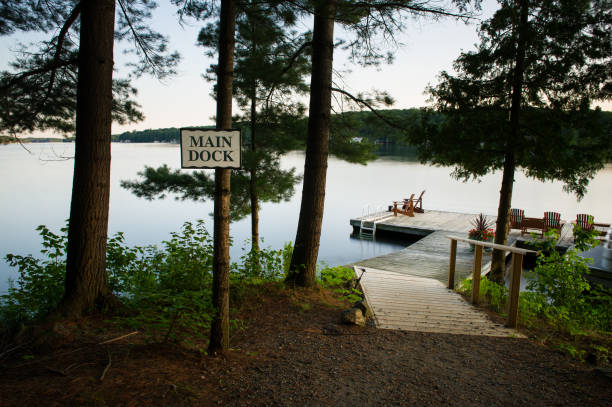 istock Adirondack chairs sitting on a wooden dock at sunrise 953465148