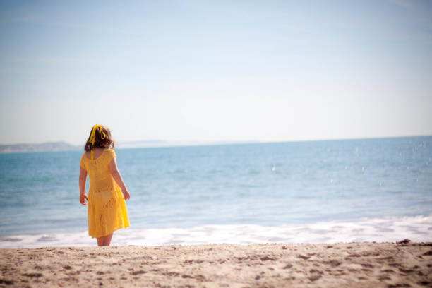 istock Happy little girl running on the beach 953465986