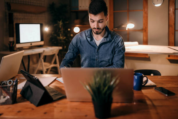 istock Tired men working in office at night 953466460
